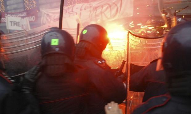 Demonstrators protest the Italian government outside La Scala Demonstrators (back), protesting against the Italian government's austerity budget cuts, clash with riot policemen outside La Scala