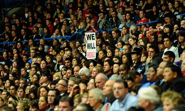The crowd reacts Wednesday night to President Obama's efforts towards national healing in Tucson, Ariza.