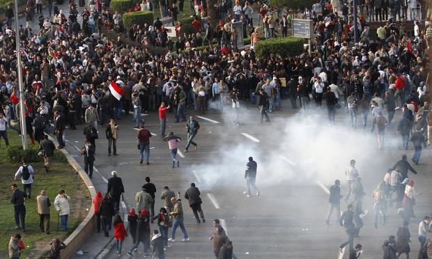 Egyptian demonstrators protest in central Cairo amidst tear gas fire by Egyptian police to demand the ouster of President Hosni Mubarak and calling for reforms on January 25, 2011.