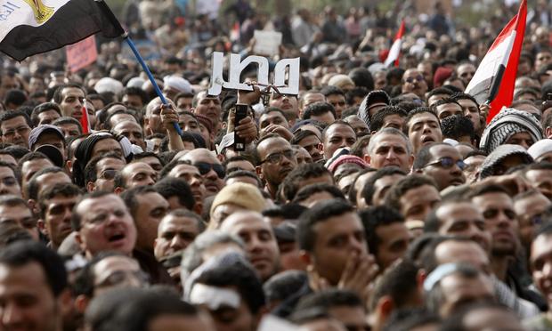 Egyptian anti-government protesters hold up the name of Egypt in Arabic at Tahrir Square during a protest in Cairo on February 4, 2011.