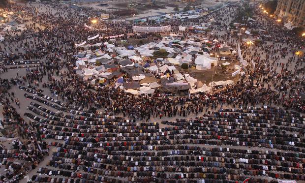 A general view shows Egyptian anti government protesters praying at sunset on Cairo's Tahrir Square, on February 7, 2011, on the 14th days of protests calling for an end to Hosni Mubarak's regime.