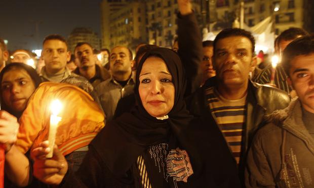 An Egyptian anti-government demonstrator takes part in a candlelight vigil at Cairo's Tahrir Square on February 9, 2011 on the 16th day of consecutive protests calling for the ouster of Mubarak.