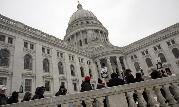 Protesters rally outside the Wisconsin State Capitol on February 21, 2011 in Madison, Wisconsin.