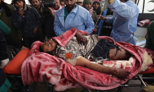 A rebel militiaman is brought into a hospital after being seriously wounded on the frontline on March 8, 2011 near Ras Lanuf, Libya.