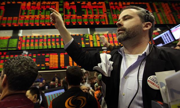 A trader signals an offer in the corn options pit at the CME Group March 15, 2011 in Chicago, Illinois. U.S. stock and commodity prices tumbled following a sharp drop in Japan's stock market.