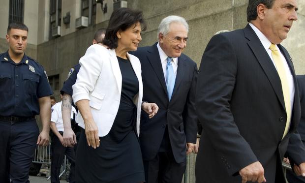 International Monetary Fund leader Dominique Strauss-Kahn (C) and his wife Anne Sinclair leave New York State Supreme Court on July 1, 2011 in New York City.