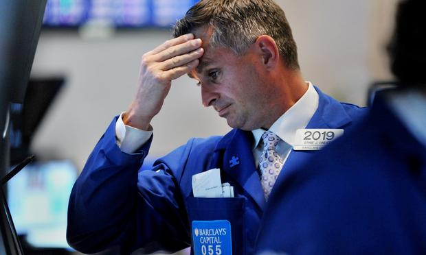 A trader reacts to the market on the floor of the Stock Exchange. A trader reacts to the market downfall on the floor of the New York Stock Exchange at the closing bell August10, 2011.