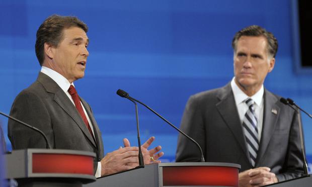Republican presidential candidates, Texas Gov. Rick Perry (L) speaks as former Massachusetts Gov. Mitt Romney listens in the Fox News/Google GOP Debate on September 22, 2011 in Orlando, Florida.