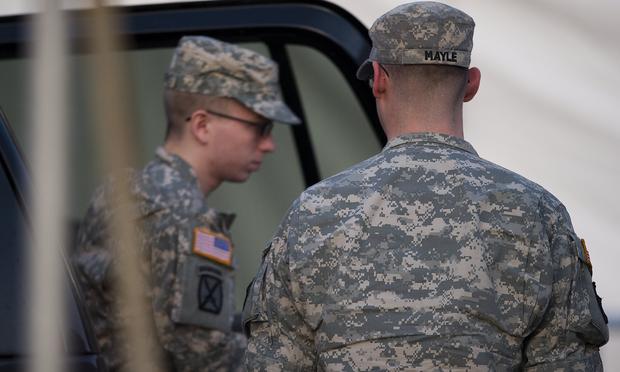 US Army Private First Class Bradley Manning (L), surrounded by US military, arrives at a US military Magistrate Court facility during an Article 32 hearing at Fort Meade, Maryland on December 19, 2011