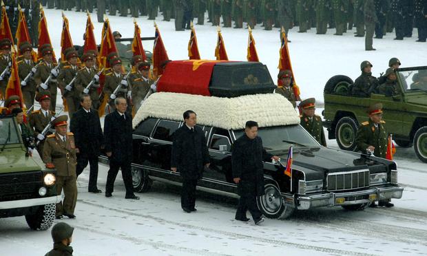 Kim Jong-un (center R) besides the convoy carrying the body of his father and late leader Kim Jong-il at Kumsusan Memorial Palace in Pyongyang on December 28.