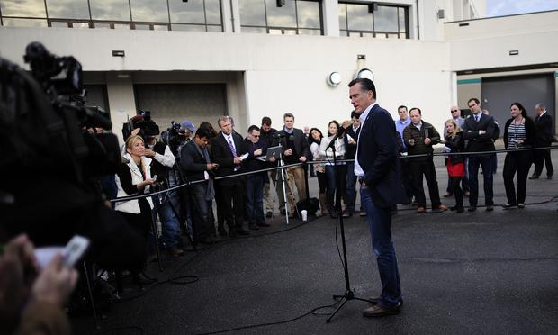 Republican presidential hopeful Mitt Romney talks to journalists after a campaign rally in Florence, South Carolina, January 17, 2012.