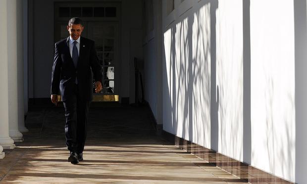 US President Barack Obama walks along the colonnade at the White House in Washington, DC, on January 24, 2012.