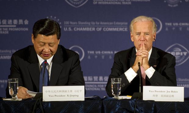 Chinese Vice President Xi Jinping (L) speaks with US Vice President Joe Biden (R) during a business roundtable at the US Chamber of Commerce in Washington, DC, February 14, 2012.