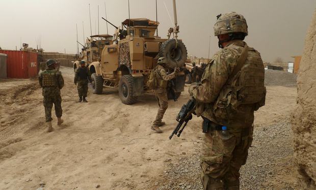 US soldiers keep watch at the entrance of a military base following the shooting of Afghan civilians allegedly committed by a rogue US soldier in Kandahar province on March 11, 2012. US soldiers keep watch at the entrance of a military base following the shooting of Afghan civilians allegedly committed by a rogue US soldier in Kandahar province on March 11, 2012.