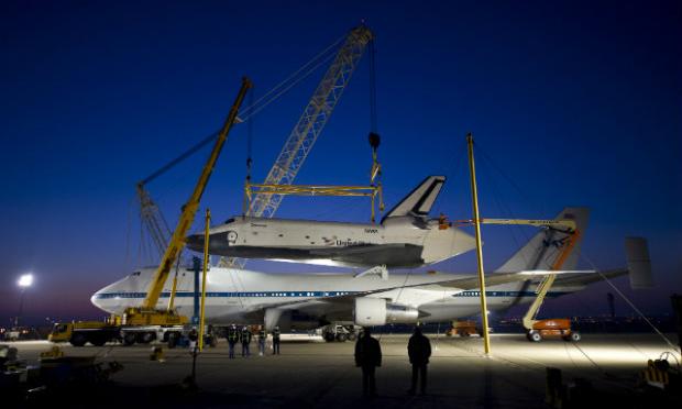 The Enterprise was prepared for its trip to the NYC on Friday. Weather has delayed the flight. The space shuttle Enterprise gets set up for its trip to NYC.