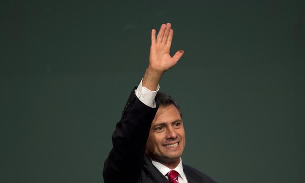 Mexican President Enrique Peña Nieto celebrates after learning the first official results of his election.