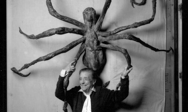 Artist Louise Bourgeois stands before her sculpture 'Spider IV,' in 1996.