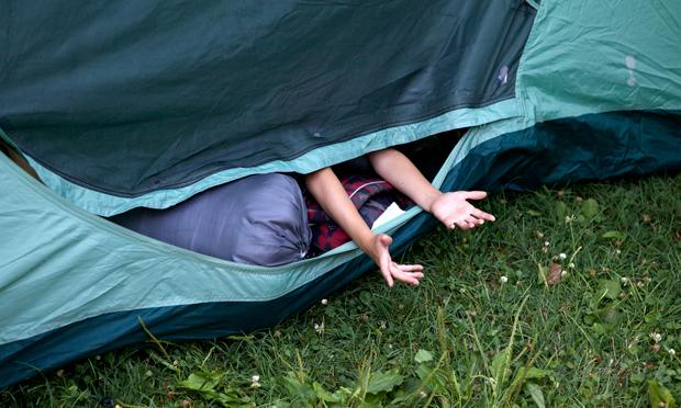 Campers fill their tents, while avoiding mosquitoes from flying into the tent. Campers fill their tents, while avoiding mosquitoes from flying into the tent.