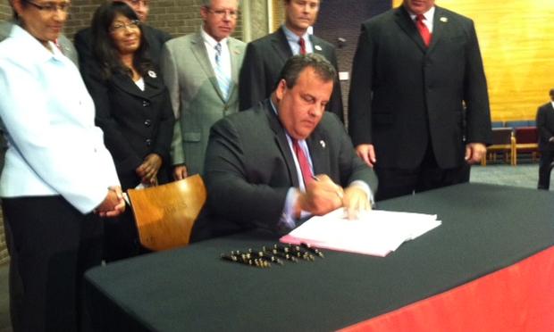 New Jersey Governor Chris Christie signs his education restructuring bill.