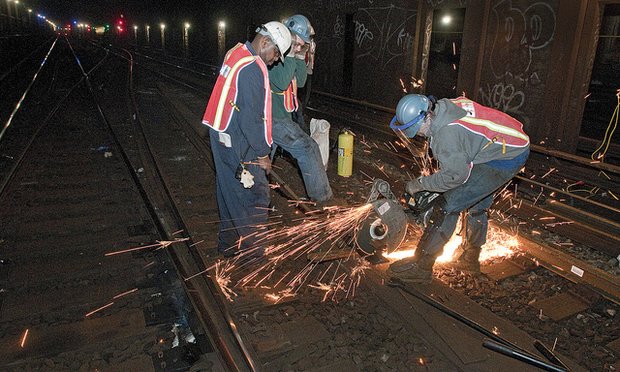 Fastrack workers repairing subway track