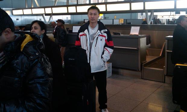 Traveler waiting in line at JFK Airport.