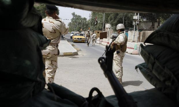 Iraqi soldiers man a checkpoint in central Baghdad.