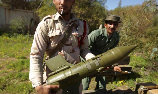 Libyan rebels hold anti-tank rockets in Benghazi.