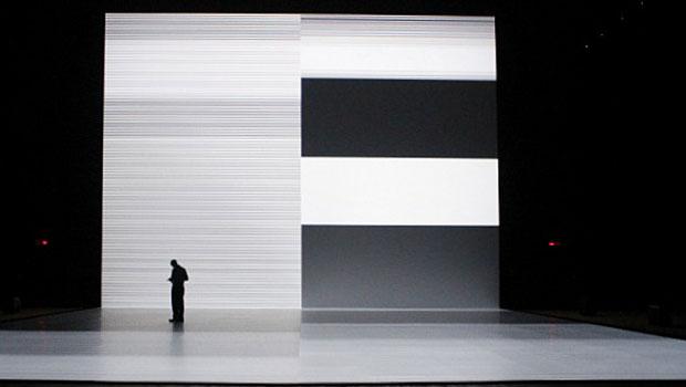 A man looks at another screen (his phone) while in the installation. A man looks at another screen (his phone) while in the installation.