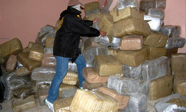 A policeman piles packages of confiscated marijuana in Nuevo Laredo, Tamaulipas state, Mexico, on the border with the United States