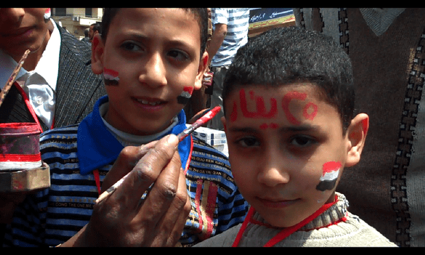 A young boy gets 'January 25' painted on his face in Tahrir Square on Friday.