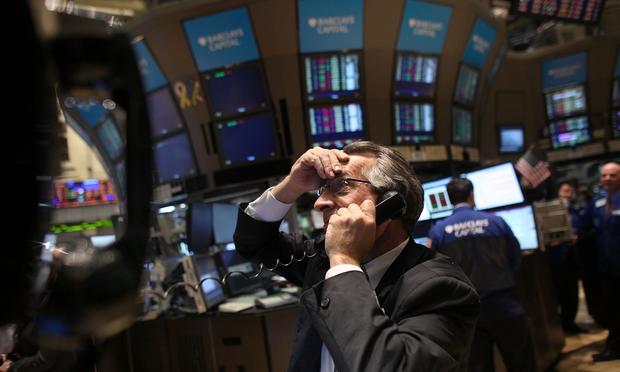 Traders work on the floor on the New York Stock Exchange on April 18, 2011 in New York City following news that Standard and Poor's had cut its long-term outlook on U.S. debt to negative.