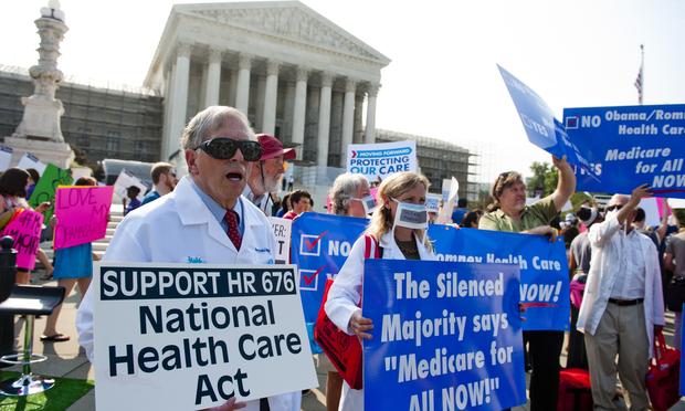 Demonstrators protest as they await a decision by the US Supreme Court on the constitutionality of the Affordable Healthcare Act.