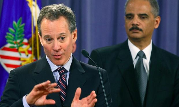 New York Attorney General Eric Schneiderman (L) speaks whille Attorney General Eric Holder listens during a news conference at the Justice Department on January 27, 2012 in Washington, DC.