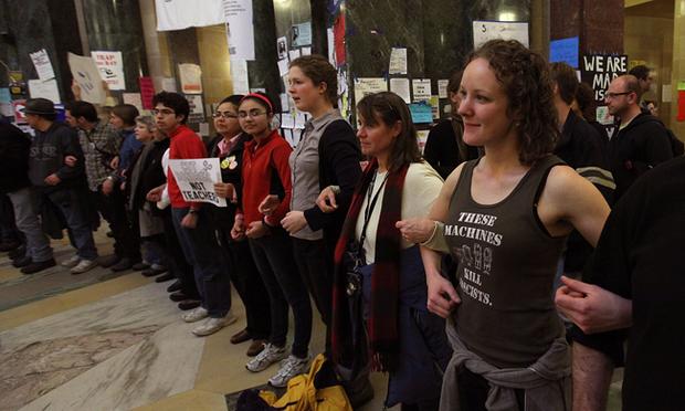 Authorities attempt to eject protestors from Wisconsin.