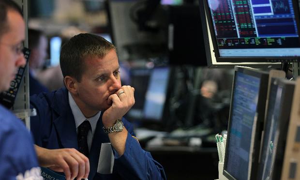 Traders work on the floor during afternoon trading at the New York Stock Exchange.