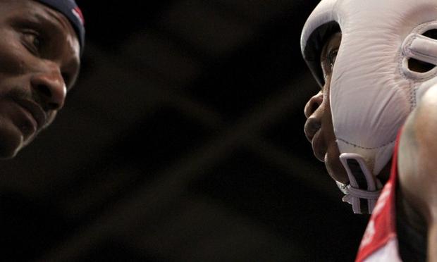 Tyrieshia Douglas listens to Coach Calvin Ford before stepping into the ring to face her opponent.