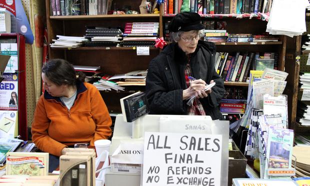 Roslyn Bergenfeld behind the register at the Civil Service Bookshop. Her husband opened up the store 62 years ago.