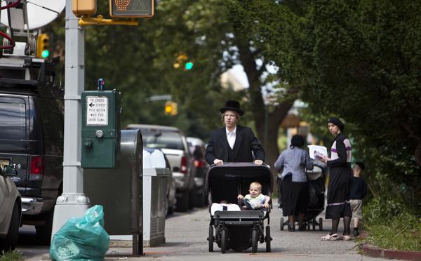 Many members of the ultra-Orthodox community in Borough Park, Brooklyn, choose not to vaccinate their children. A Hasidic man pushes a stroller near the residence of Leibby Kletzky, a murdered eight-year-old boy who went missing from the Hasidic neighborhood of Borough Park, Brooklyn.