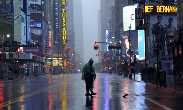 A man walks across 42nd Street in Times Square in New York on August 28, 2011 as Hurricane Irene hits the city and Tri State area with rain and high winds. A man walks across 42nd Street in Times Square in New York on August 28, 2011 as Hurricane Irene hits the city and Tri State area with rain and high winds.
