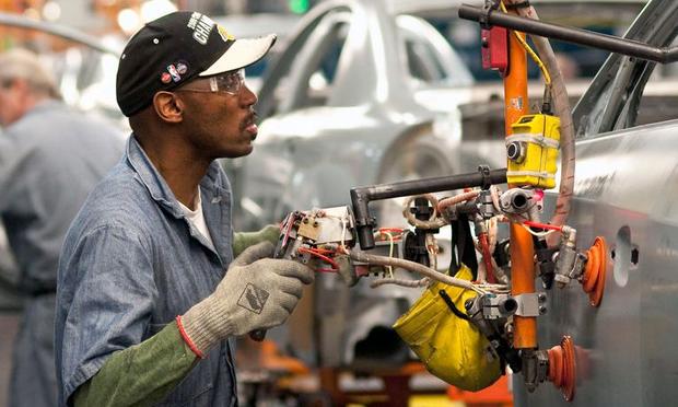 Workers install doors on Chevrolet Malibu and Buick LaCross vehicles April 21, 2010 at the General Motors plant in Fairfax, Kansas.