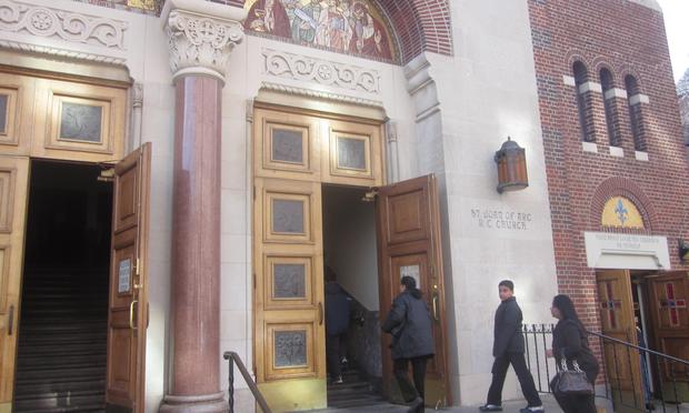 Worshipers enter St. Joan of Arc church