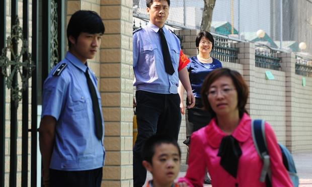 Guards monitor the gates at a Chinese school