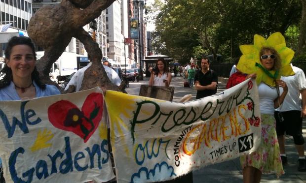 Activists from the environmental group Time’s Up! protest in front of City Hall in support of community gardens.