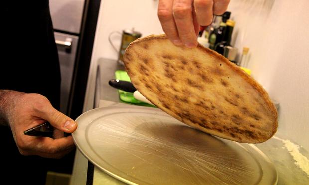 Evidence of a pizza stone: Dark spots on the bottom indicate 'pure flavor' according to Bello.