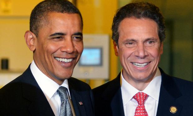 US President Barack Obama smiles with New York Governor Andrew Cuomo (R) during a tour of the of Nanoscale Science and Engineering’s (CNSE) Albany NanoTech Complex at SUNY