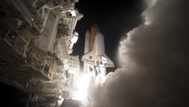 An exhaust cloud billows around Launch Pad 39A at NASA's Kennedy Space Center in Florida as space shuttle Discovery lifts off to begin the STS-131 mission.