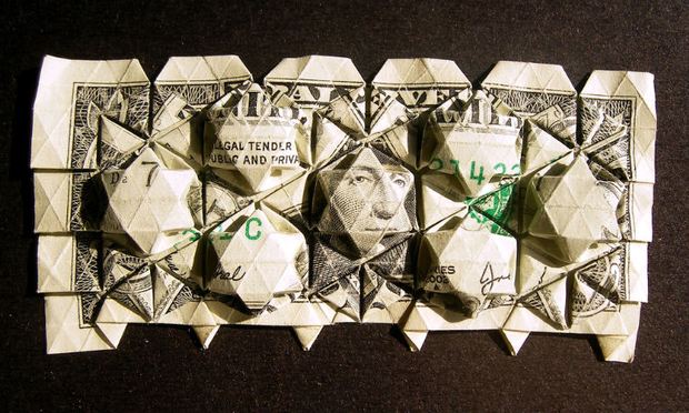 The complicated market in financial derivatives is run by a closed and secret group of bankers from the nation's largest financial institutions. dollar, folded