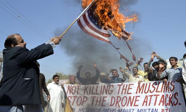 A Pakistani protester holds a burning US flag during a protest on February 9, 2012 against the US drone attacks in the Pakistani tribal region.