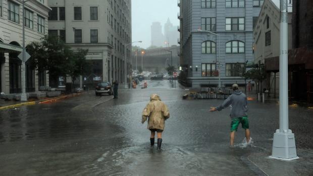 Nancy Zakhary and Eddie Lima of Brooklyn wade through flood waters in Brooklyn on August 28, 2012. Nancy Zakhary and Eddie Lima of Brooklyn wade through flood waters filling the intersection of Main St and Plymouth St in Dumbo Brooklyn as Hurricane Irene reaches the New York City Area on August 28,