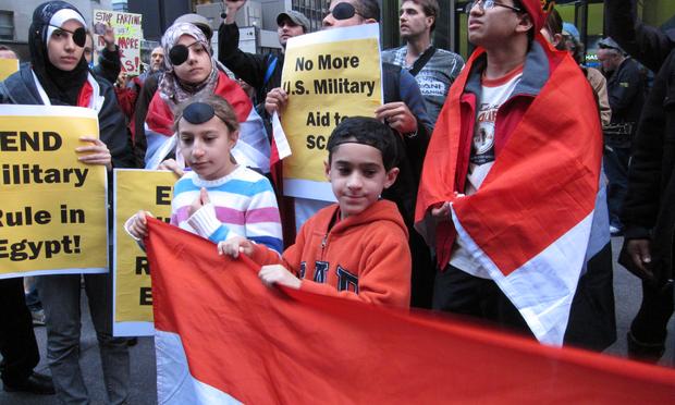 About 75 Egyptian Americans and their supporters gathered in midtown to protest against an investment firm that owns the majority shares of a company selling tear gas to the Egyptian military.